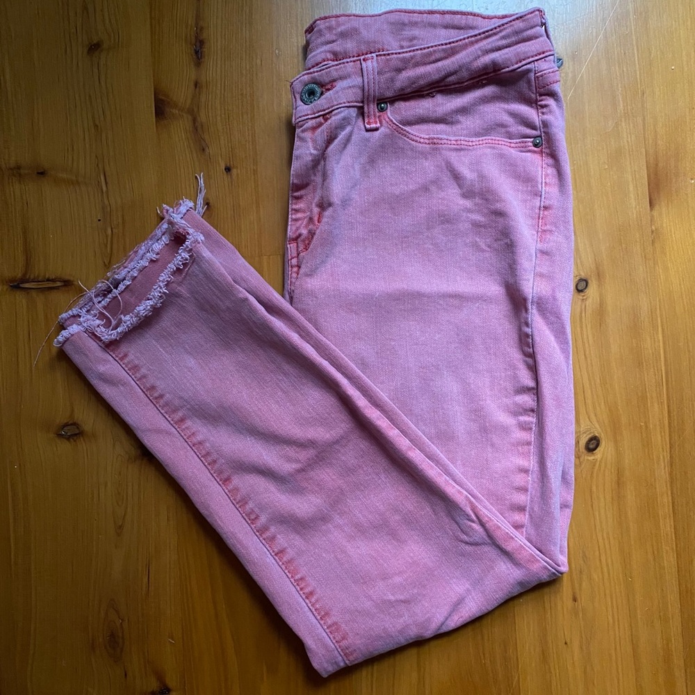 Washed red Levi’s with raw hem